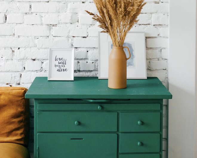 drawers with a vase and decorative picture frames